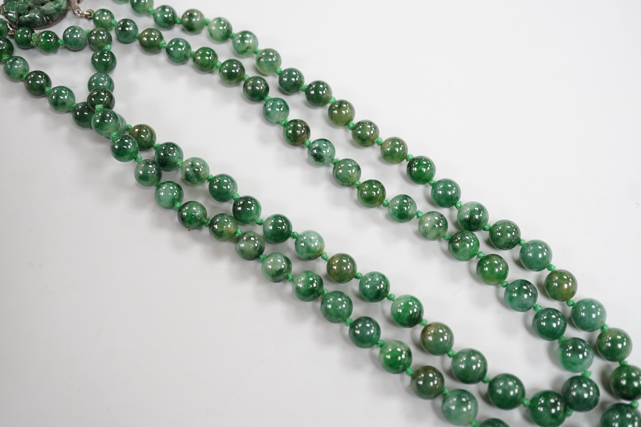 A double strand jade bead necklace, with carved jade and white metal clasp, 45cm, gross weight 101 grams.